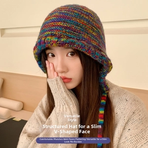 Detail of chunky knit bucket hat featuring colorful mixed yarn and rainbow drawstrings