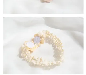 Detailed close-up of handmade lace baby headband with soft felt backing for comfort