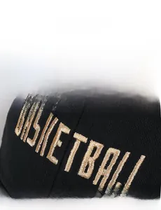 Close-up of golden BASKETBALL embroidery on a premium black cotton baseball cap