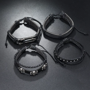 4-piece men's punk leather bracelet set with silver guitar and skull charms on dark background