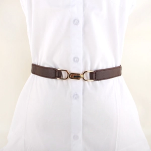 Minimalist brown elastic waist belt with gold metal buckle on a white dress shirt