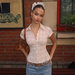 Detail of pink plaid short sleeve shirt with button-down collar and waist-slimming fit