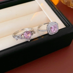Detailed view of silver crown rings with sparkling pink zircon in a jewelry box