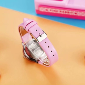 Close-up of pink leather watch strap and silver metal buckle on children's watch