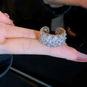 Close-up of sparkling zircon flower wide open ring featuring a crystal-paved silver band