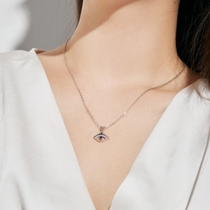 Detail of S925 sterling silver evil eye necklace with blue gemstone and white diamonds
