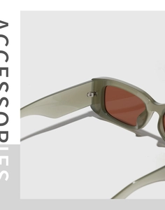 Detailed close-up of retro square sunglasses featuring olive green frames and metal hinges