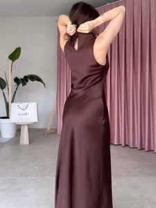 Elegant sleeveless dark brown satin maxi dress with backless design and slim silhouette