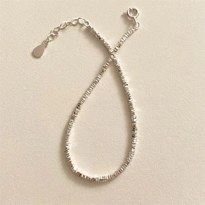 Macro detail of S925 sterling silver beaded bracelet with adjustable spring ring clasp