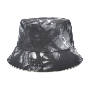 Detail of a tie-dye bucket hat in black and gray, featuring high-quality cotton fabric texture