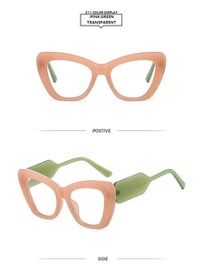 Detail view of pink and green transparent cat-eye glasses frame with contrast colors
