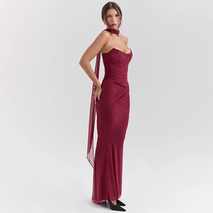 Detailed view of burgundy strapless dress featuring ruched fabric and long side ribbon