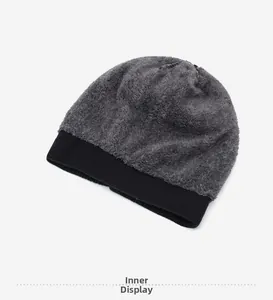 Detail of warm grey fleece lining and black ribbed knit edge on a winter beanie hat