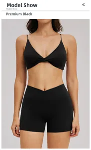 Detail of premium black yoga set featuring a front twist sports bra and V-cross waist shorts