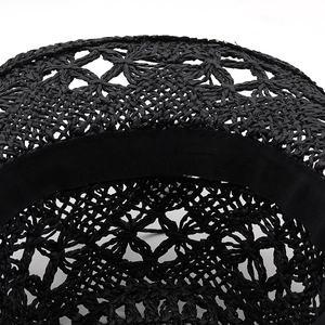 Interior detail of black hollow hand-woven paper straw cowboy hat with sweatband