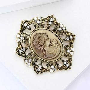 Detail view of a vintage cameo brooch with a brown profile bust and sparkling rhinestones