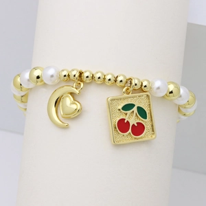 Detail of beaded bracelet with gold metal beads, white pearls, and cherry pendant charm