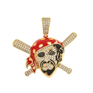 Detailed view of a gold pirate skull pendant with red enamel and inlaid crystals