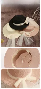 Close-up of summer straw hats with elegant tulle ribbon and faux pearl decorations