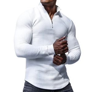 Detail of white waffle texture fabric and quarter-zip collar on men's long sleeve top