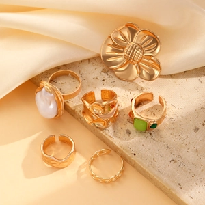 Vintage Baroque pearl ring set with gold floral designs on beige stone and satin