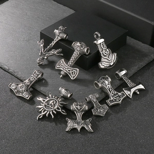 Detailed view of various Viking Thor's Hammer pendants with wolf head and Celtic knot motifs