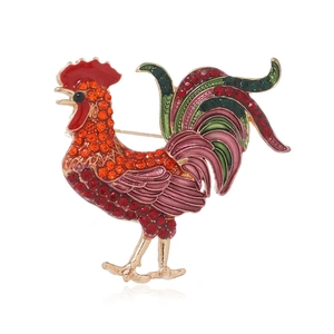 Detailed close-up of a colorful enamel rooster brooch with sparkling inlaid rhinestones