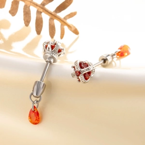 Silver crown cartilage earrings with red stones and orange teardrop gems on ceramic