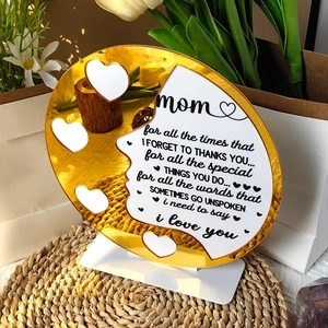 Macro shot of heart-shaped acrylic Mother's Day plaque with golden mirror finish on base