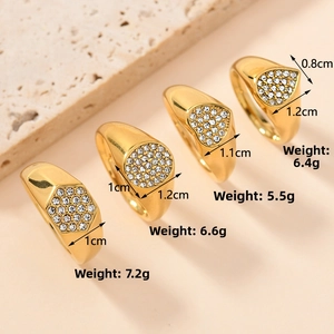 Detailed view of four gold-plated stainless steel rings with zircon pave settings