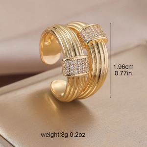 Detailed macro shot of multi-layer golden braided ring with inlaid cubic zirconia
