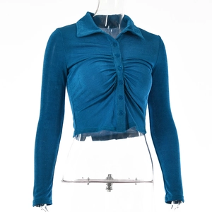 Close-up of blue long sleeve cropped polo shirt featuring front ruching and six buttons