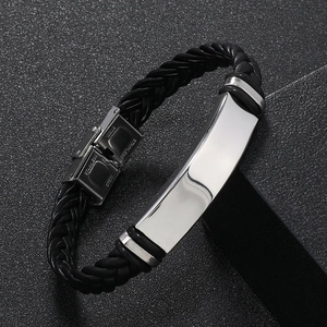 Detail of black braided leather bracelet with silver polished stainless steel clasp