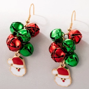 Detail of Christmas earrings featuring red and green bells with Santa Claus charms