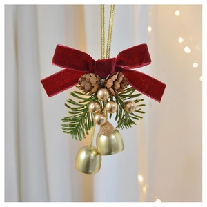 Close-up of a Christmas ornament with velvet bow, pine cones, needles, and gold bells