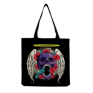 Detailed close-up of skull and wings graphic print on black canvas tote bag