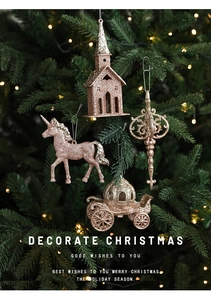 Detail of champagne glitter Christmas ornaments including castle and unicorn shapes