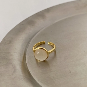 Detail of S925 sterling silver ring with cat eye stone on a sleek metal tray