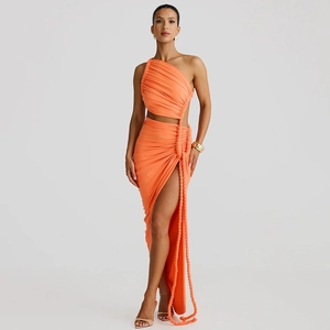 Detail of orange one shoulder dress with waist cutout and side slit drawstring