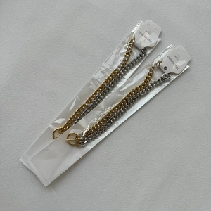 Detail of 9mm stainless steel two-tone cuban necklaces with OT toggle closure in packaging