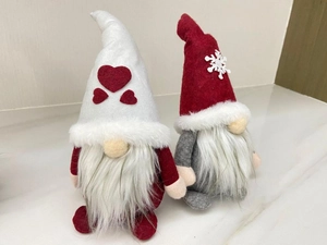 Detail of plush Christmas gnomes with heart and snowflake patterns on their pointed hats