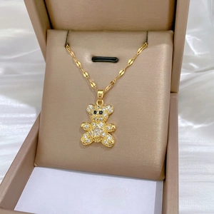Luxurious gold bear pendant necklace with sparkling crystals on a sleek water wave chain