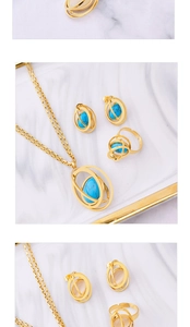 Detailed view of gold jewelry sets with turquoise and opal stones on marble surface