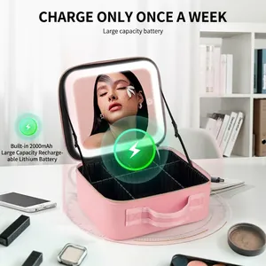 Pink PU leather makeup bag with LED mirror and adjustable dividers on a vanity