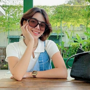 Classic pilot style black oversized sunglasses with gold digital watch and handbag