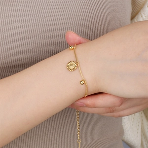 Elegant gold stainless steel sunflower bracelet on wrist with adjustable chain detail