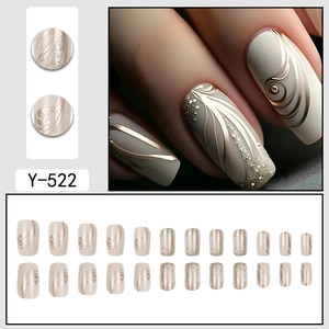 French chic off-white press-on nails with 3D gold streamline design and glitter finish