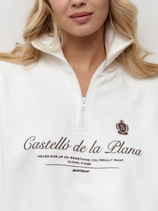 Detail of white cotton zip-up sweatshirt featuring vintage typography and soft fabric texture