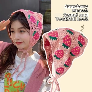Close-up of pink handmade crochet floral bandana with strawberry pattern for women