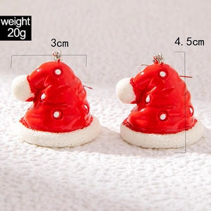 Detail showing red Christmas hat earrings with size measurements of 3cm by 4.5cm